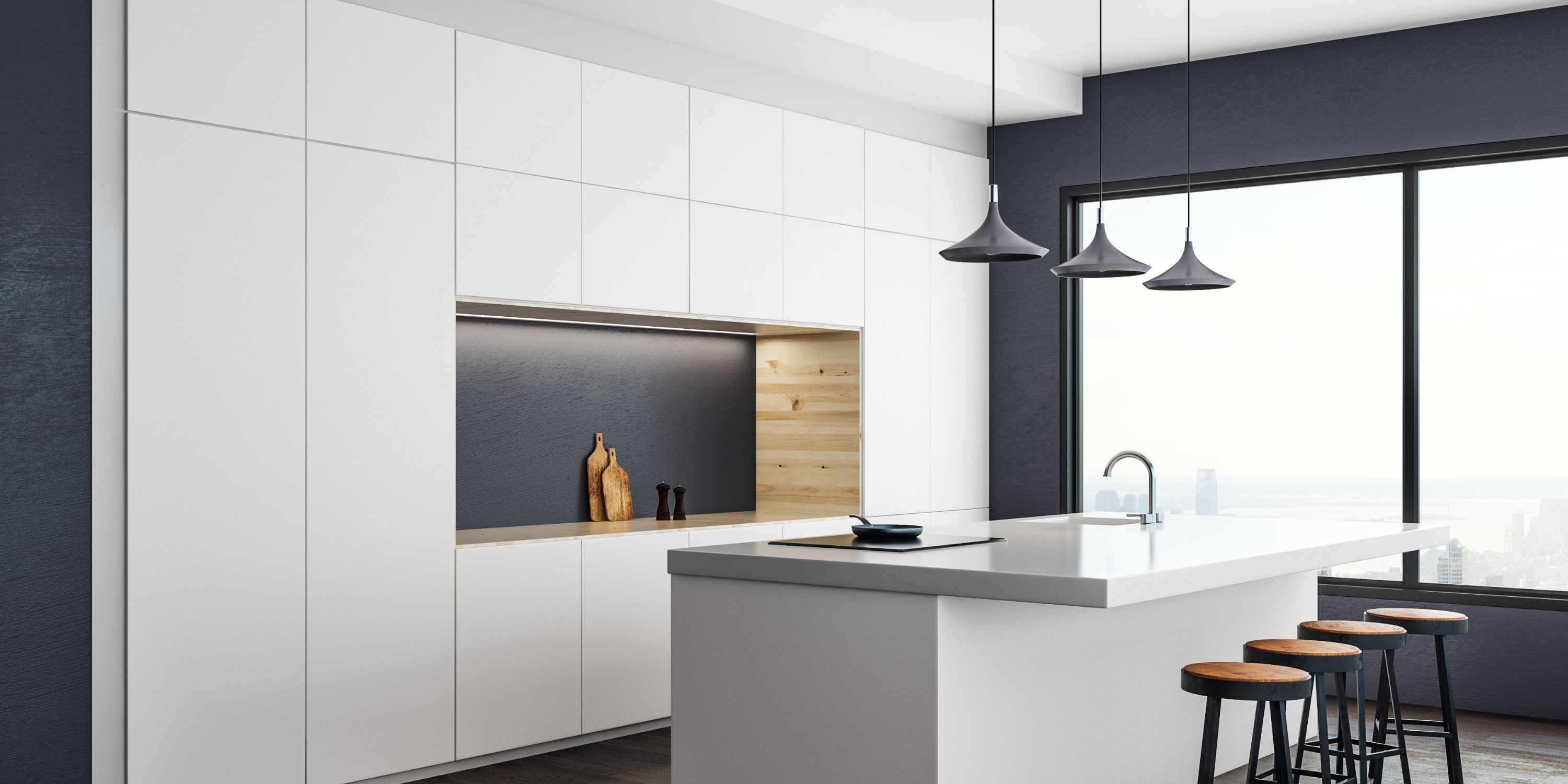 White custom kitchen with a dark accent wall and pendant lights, designed by KABCO
