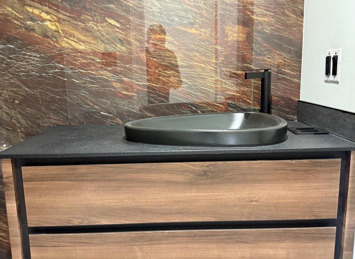 kabco- a bathroom with a wooden vanity and a black sink