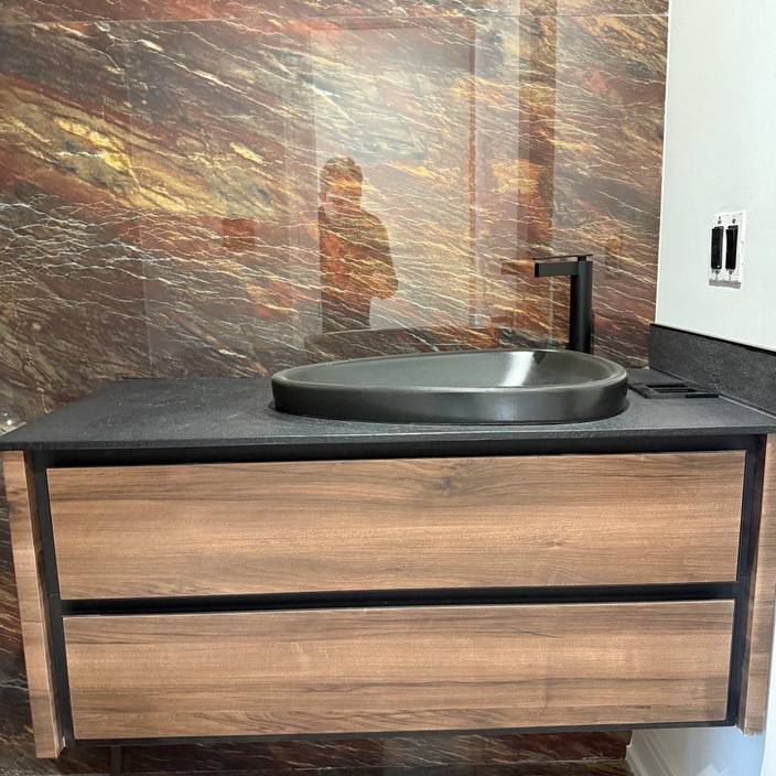 kabco- a bathroom with a wooden vanity and a black sink