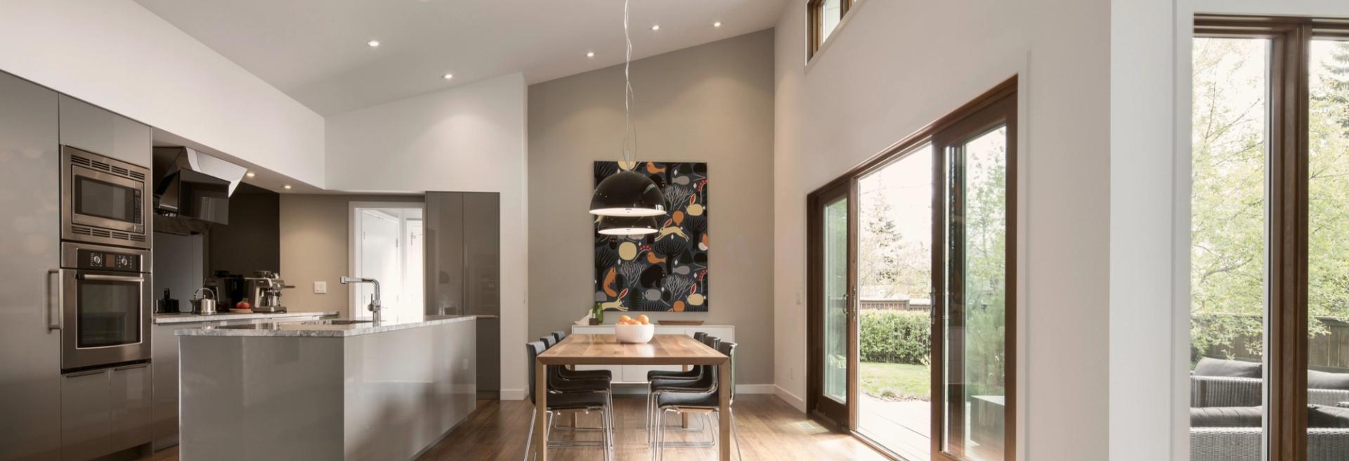 Modern kitchen with island, wood floors and floor-to-ceiling windows